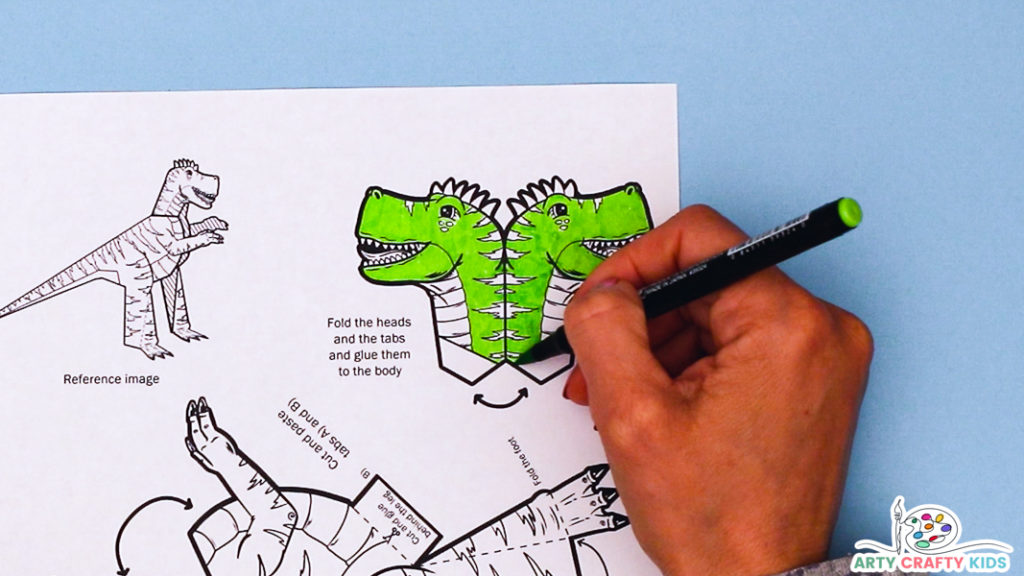 Image featuring a hand coloring in the the printable dinosaur template, starting with the T-Rex head. The T'rex is bright green.