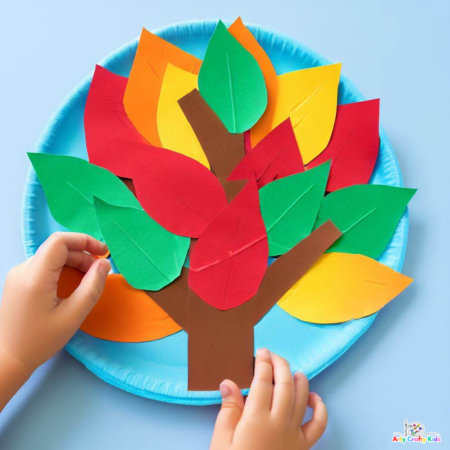 Image of a full looking Paper Plate Autumn Tree Craft with lots of yellow, orange, green and red leaves.