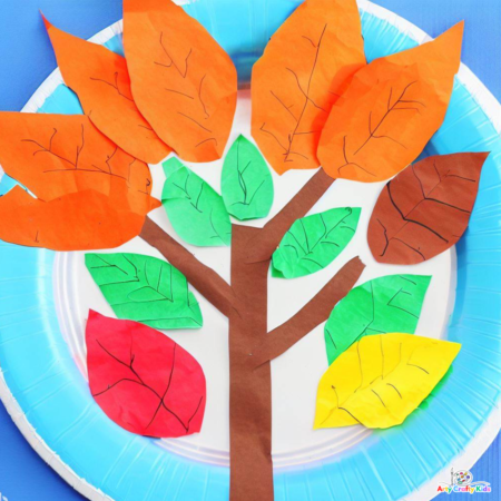 Image of a  Autumn tree arranged in layered leaves; orange at the top of the tree, followed by green and red and yellow.