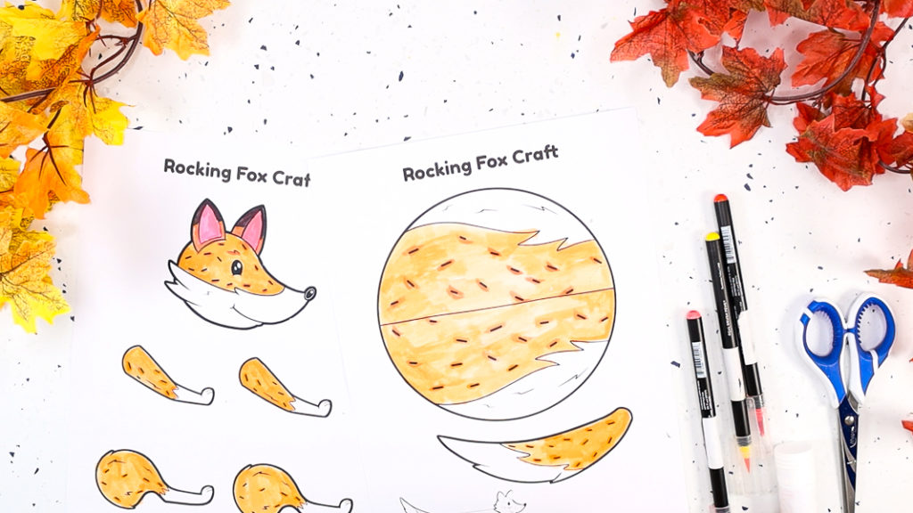 Image featuring a fox coloring craft that's completely colored in using orange pen.