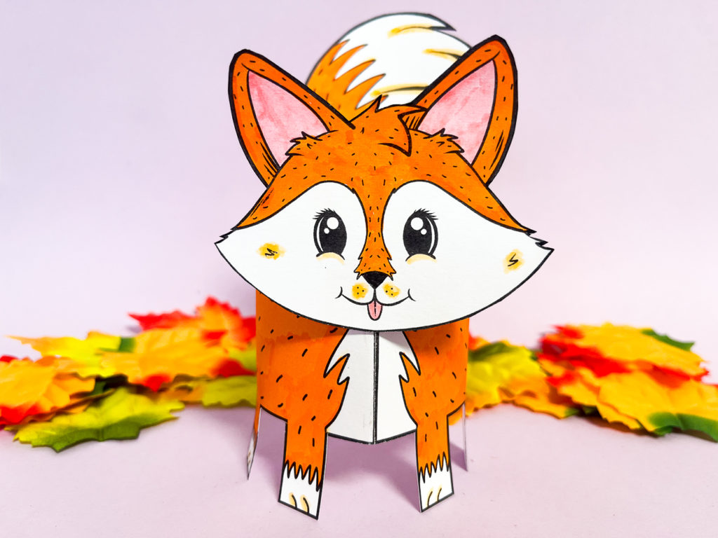 An image of a completed 3D Printable Fox Craft standing with fall leaves positioned behind it.