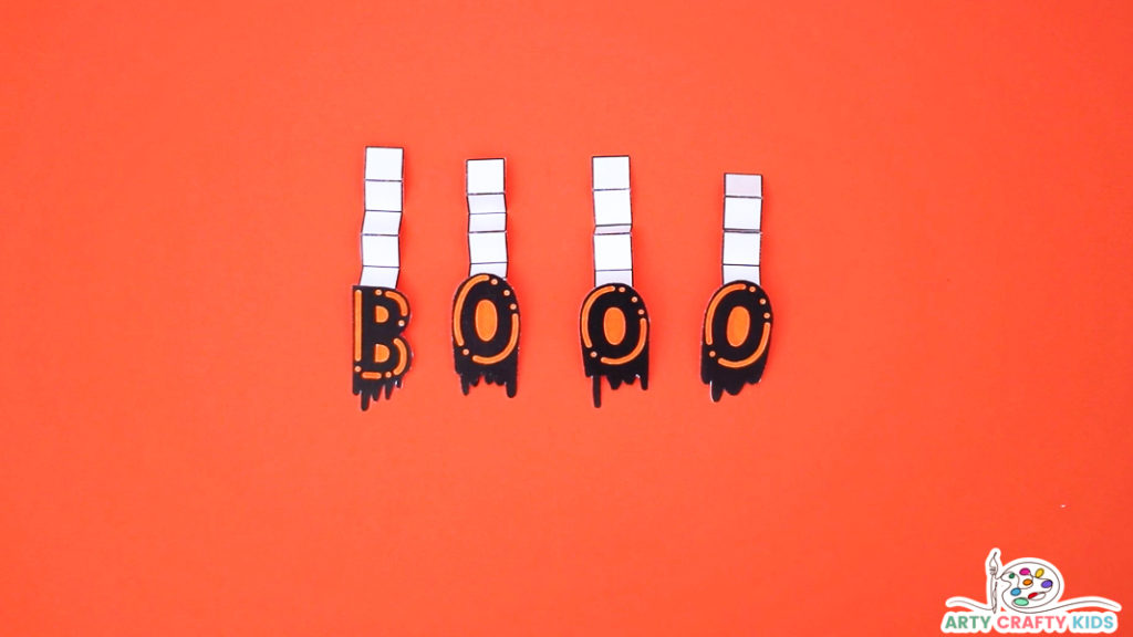 Image featuring the letters BOOO attached to end of each paper strip.