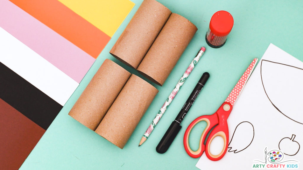 Image featuring the materials needed to make the paper roll haunted house craft, including paper rolls, paper, scissors, pencil, glue and printable haunted house template.