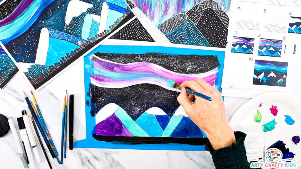 Image featuring step 9: hand painting the northern lines in shades of white, blue, pink and purple.