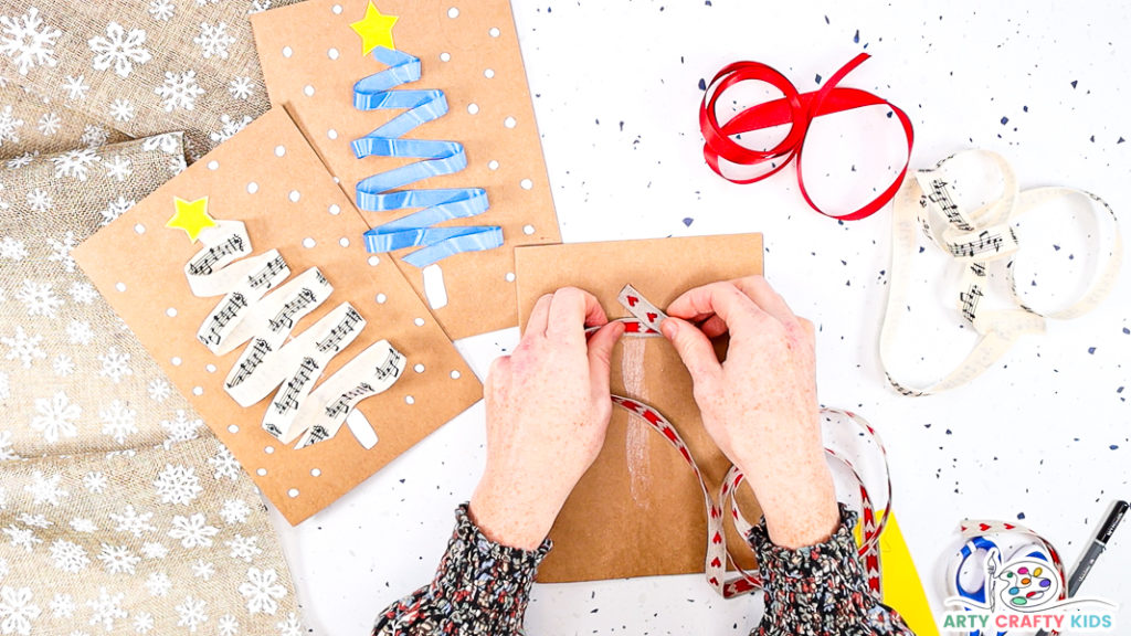 Image showing a hand glueing ribbon to the top of the gluey strip.