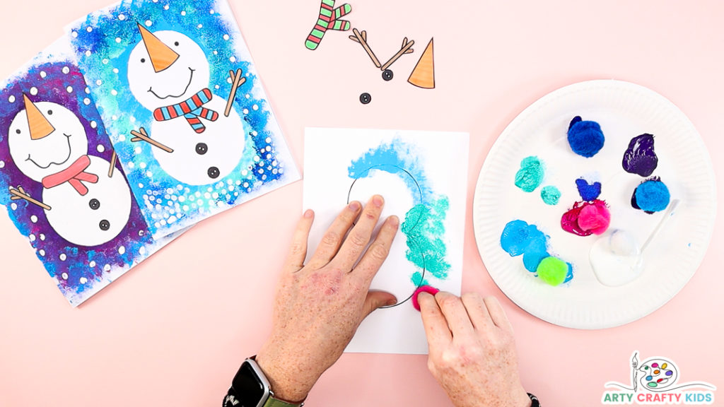 Image of a hand dabbing paint around a snowman template.