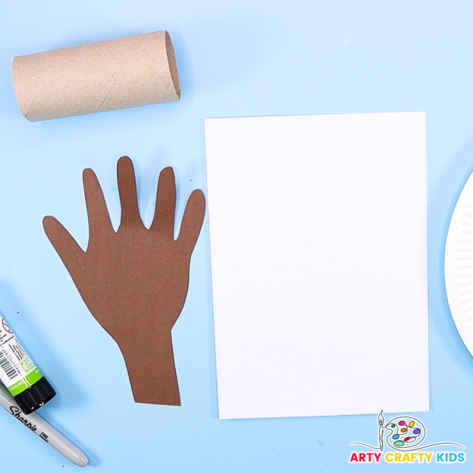 Image of a handprint traced onto colored paper and cut out. The image also shows a paper roll and folded piece of white card stock.