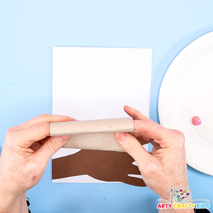 Image of a hand folding a paper roll into a heart shape.