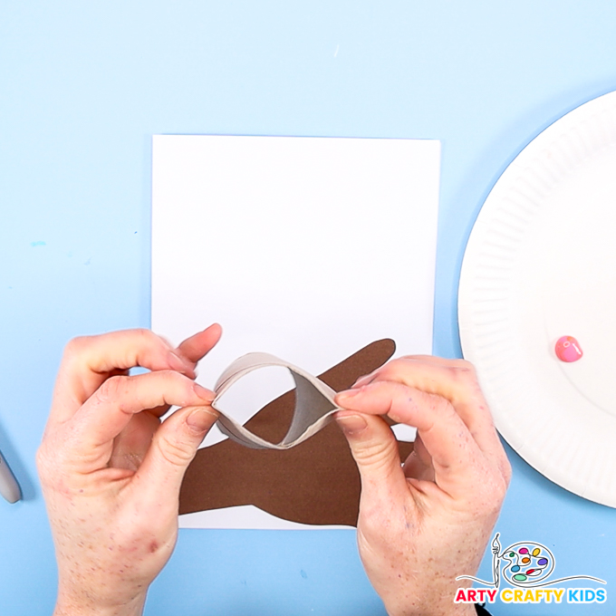Image of a hand folding the paper roll into a heart shape.