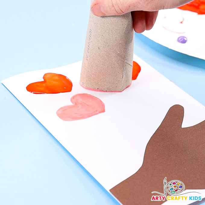 Image showcasing a paper roll printing a heart amongst a cluster of watercolor hearts.