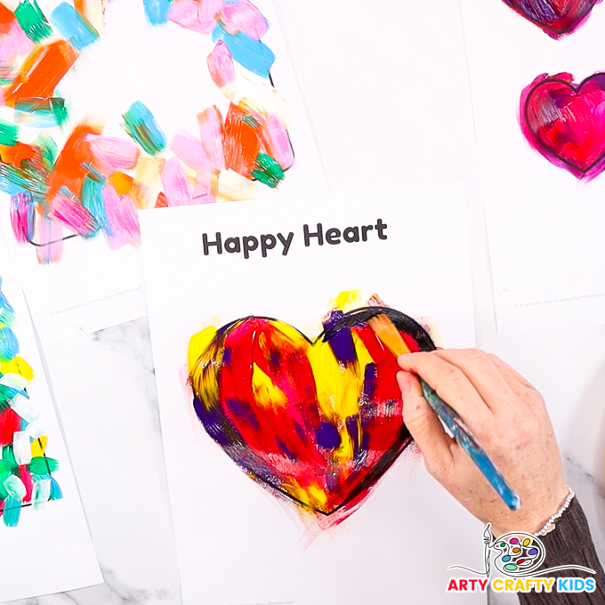 Image featuring a hand painting the heart outline black.