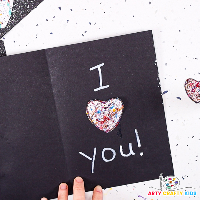 Image of an open card with I [heart] you inside - the heart is a splattered heart.