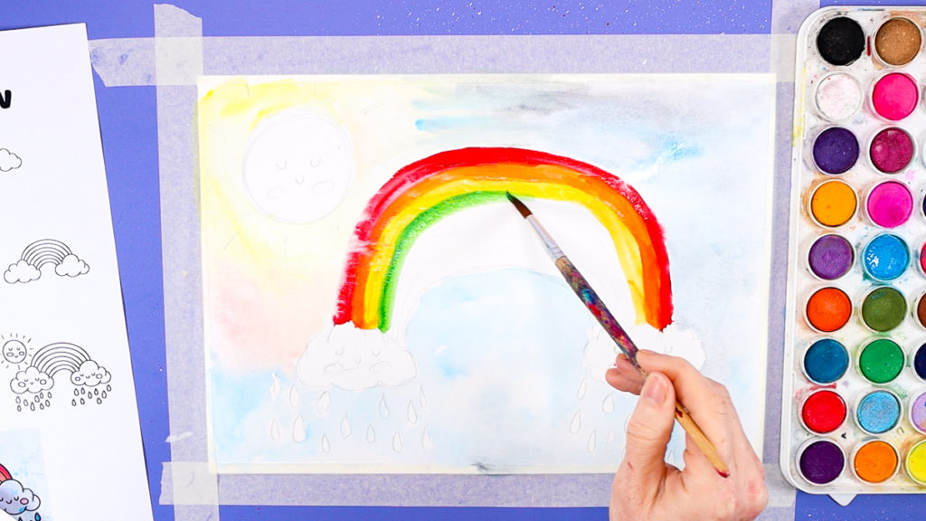 Image of a hand painting the arches of the rainbow.