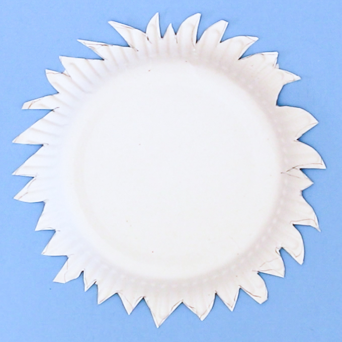 Image of a paper plate with a cut out shaggy appearance.