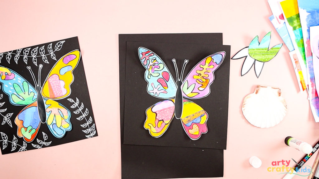 Children's art project displaying colorful Matisse butterfly collages using painted paper and freehand doodle backgrounds.