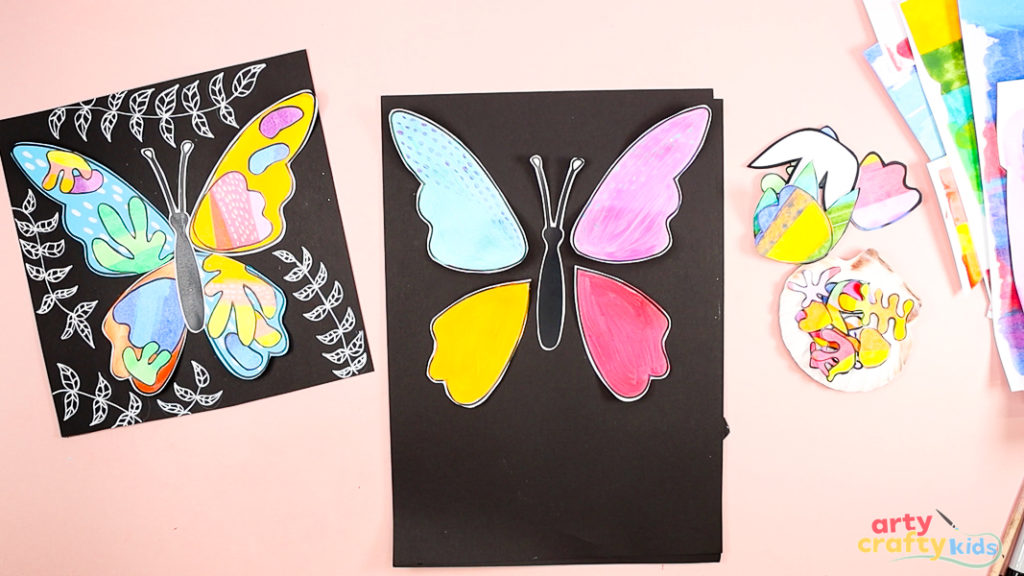 Image of the butterfly wings cut out and placed onto a sheet of black card stock.