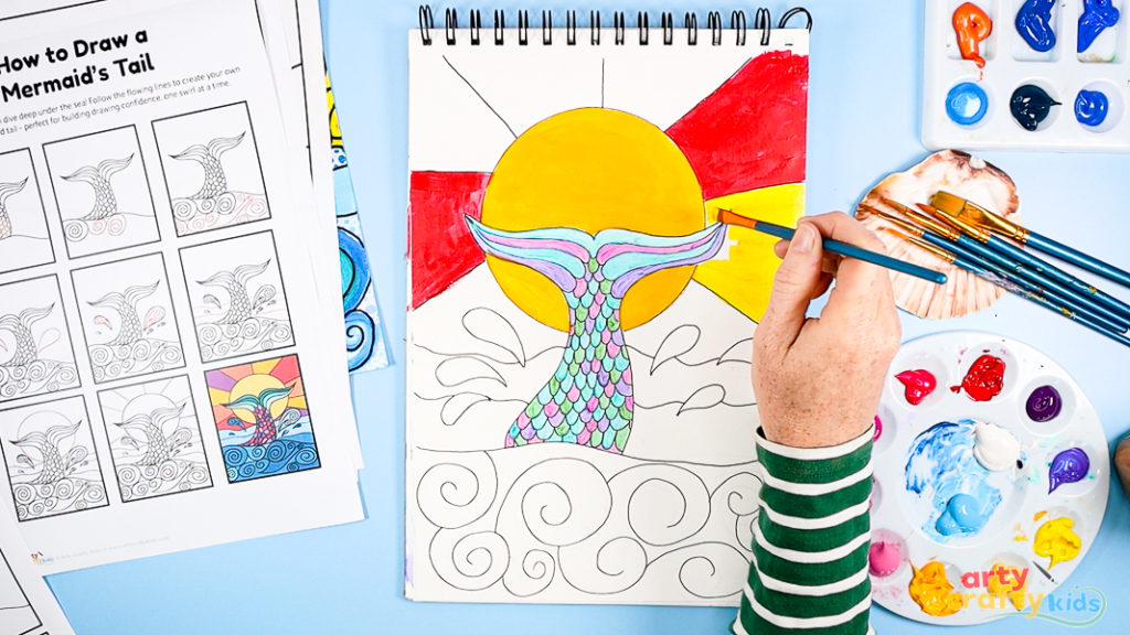 Image of Step 7: Filling the sun and rays with warm acrylic colors like yellow, orange, and pink, using blending and layering for a glowing effect.