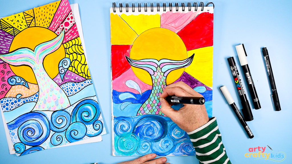 Image of Step 9: Outlining the mermaid’s tail and surrounding elements with a black marker to create strong contrast and pop-art-inspired definition.
