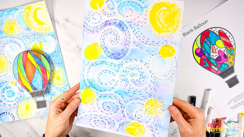 Image of hands holding up a completed starry night sky, inspired by Van Gogh, but personalised with mixed-media effects.