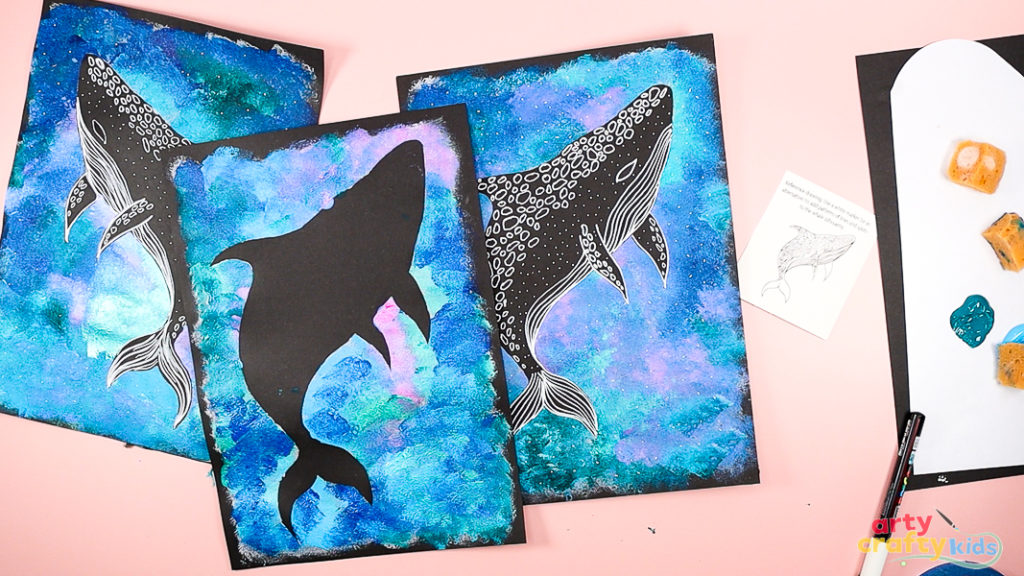 Whale shark silhouette painting featuring a bold black whale shark shape over a textured ocean background in shades of blue, purple, and pink. The silhouette is decorated with white line patterns and dots to mimic the whale shark’s markings. A simple ocean-themed art project for kids.