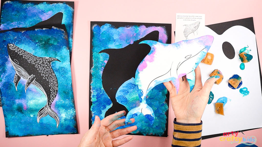 Hands are removing the Whale Shark template to reveal the silhouette.