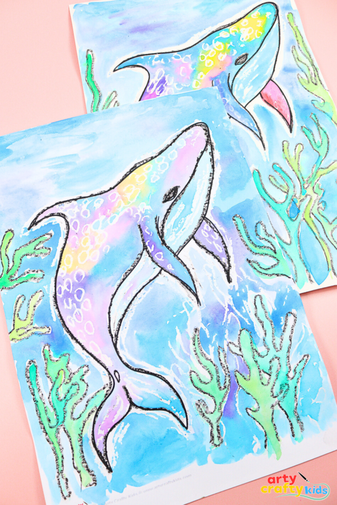 Whale shark art project for kids using watercolor paints and crayon resist technique on a blue ocean background.