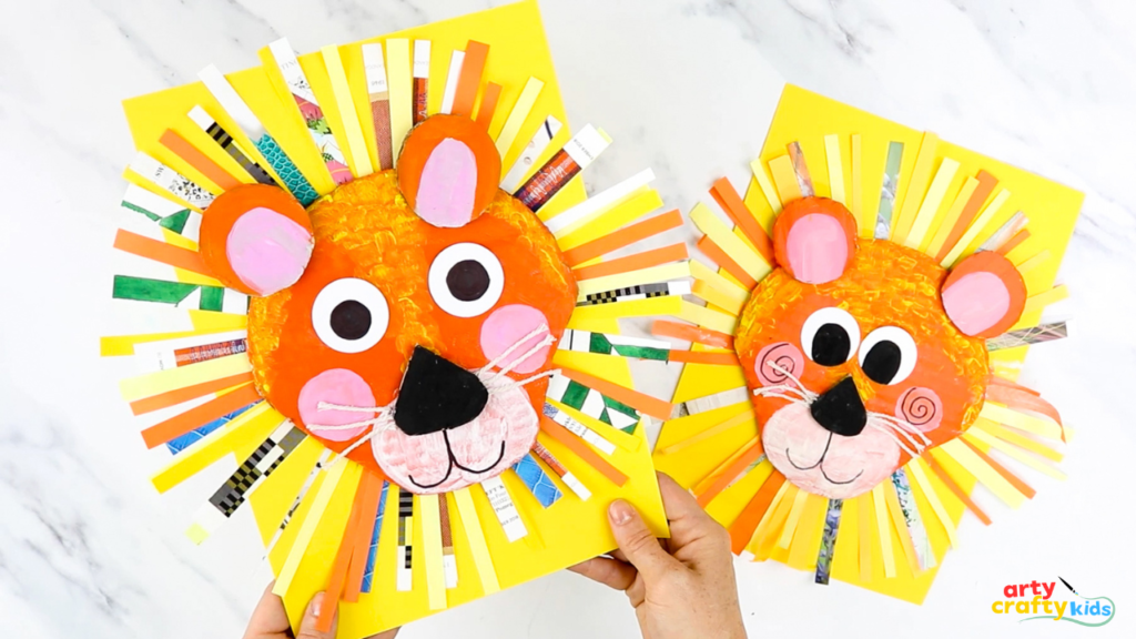 Bright and cheerful recycled cardboard lion craft for kids, featuring a colourful paper mane made from magazine strips, rosy pink cheeks, and string whiskers.