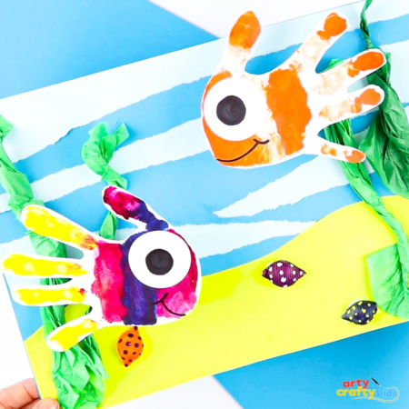 Create a fun 3D fish handprint craft for preschoolers with paint, tissue paper, and pasta shells. A simple ocean-themed art activity for kids.