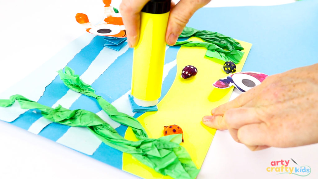 Image of a hand gluing the top of the paper spring.