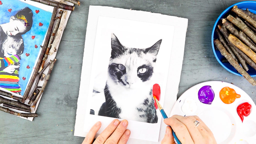 Image showing hands painting a black and white photo of a cat.