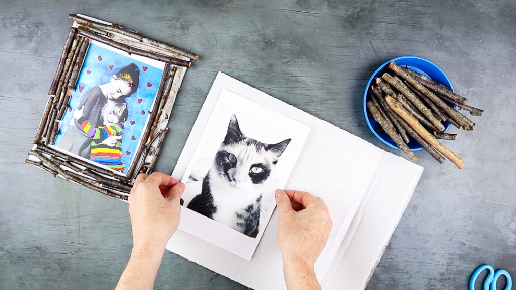 Image showing hands mounting a photo onto cardboard.