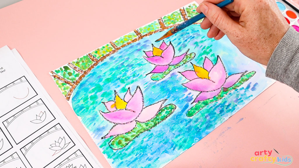 Image of a hand layering lilac paint with a flat-tipped brush over the watercolor pond.