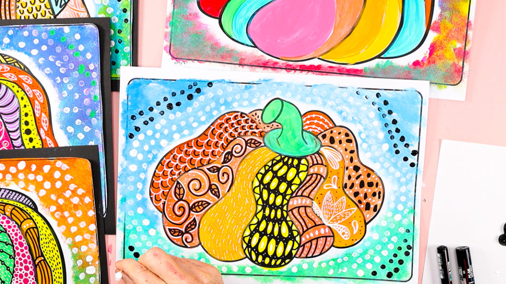 Image of a hand using a q-tip to surround the doodle pumpkin with dots. 