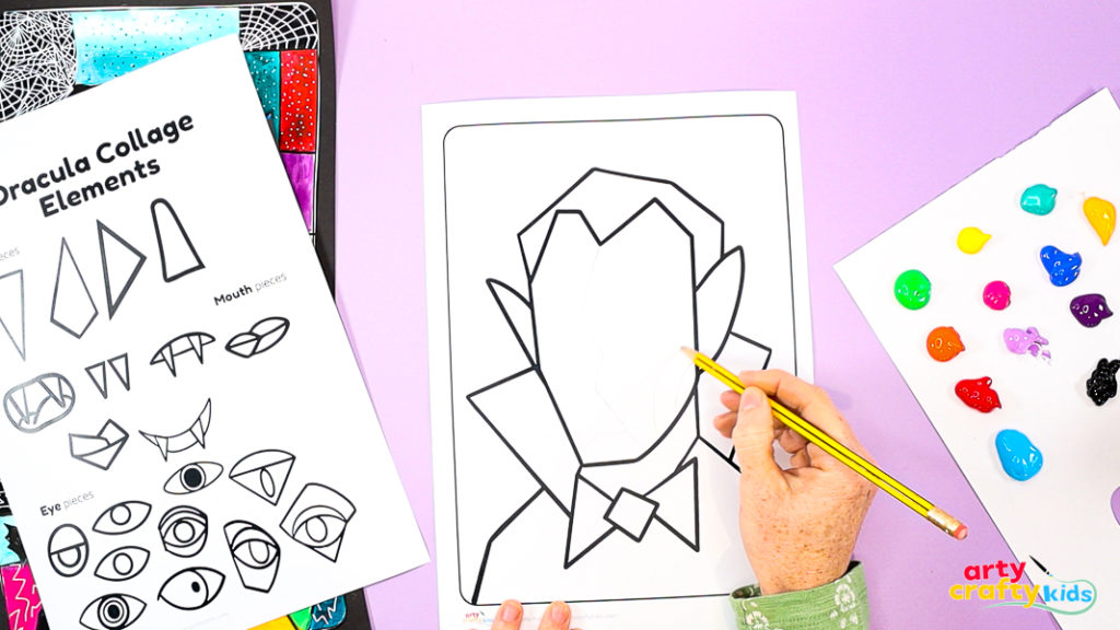 Children sketching geometric lines across a Dracula face template to plan a Cubist-inspired portrait for a Halloween collage art project.